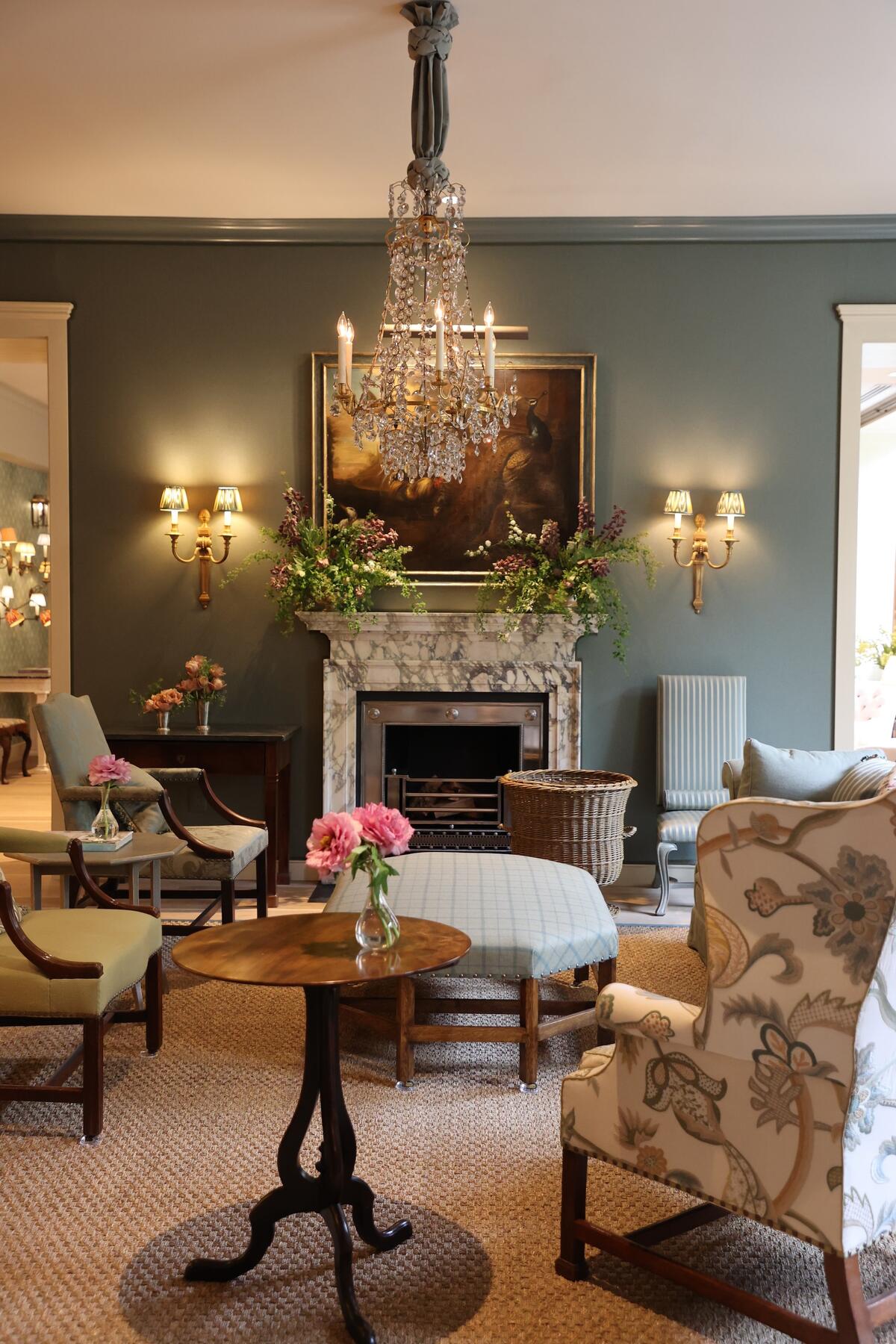 The large sitting room with upholstered walls and a marble fireplace by London-based Jamb The large sitting room with upholstered walls and a marble fireplace by London-based Jamb