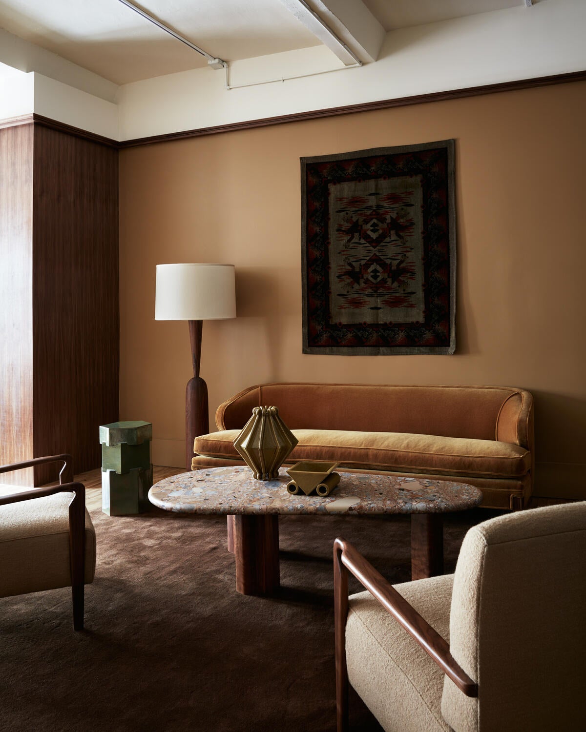 The open space is divided into a series of vignettes, using elegant walnut wing-walls and subtle shifts in color The open space is divided into a series of vignettes, using elegant walnut wing-walls and subtle shifts in color